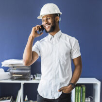 happy-african-american-engineer-talking-mobile-phone-office3